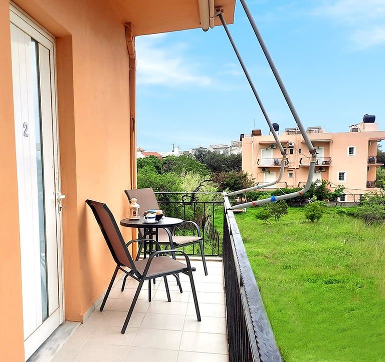a balcony with a table and chairs and a balcony