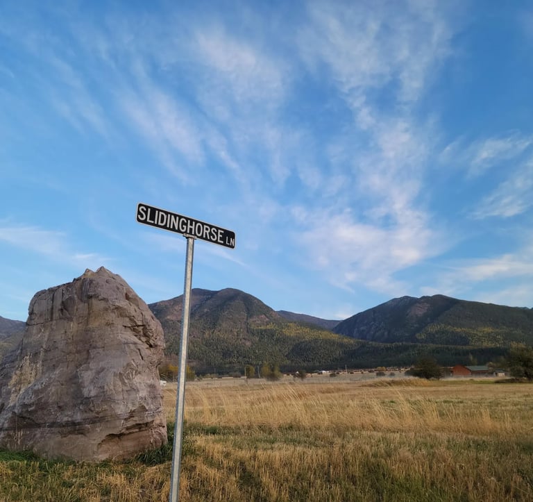 Slidinghorse Ln street sign near Arlee, MT with the Mission Mountains