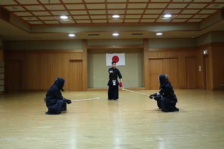 a group of people in uniform practicing kendo