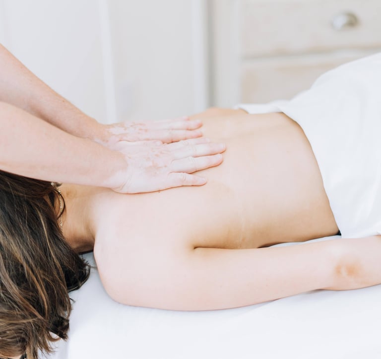 Massage therapist Laurie Kessen performing massage therapy on client's back
