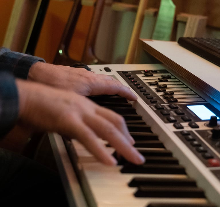 Luke Stidworthy playing a keyboard at Vox Studio