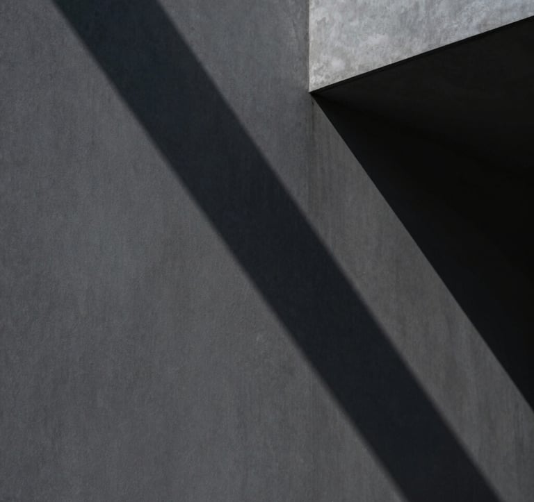 An abstract, cinematic photograph of shadows cast by sharp architectural angles on a charcoal gray wall. Minimalist and authoritative, capturing a sense of hidden depth and strategic framing. No people, North American / International Business aesthetic.
