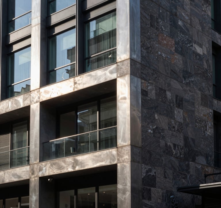 A close-up architectural shot of a contemporary building facade in Rosario, showcasing high-quality materials like brushed steel, glass, and dark stone. The style is sophisticated and urban, reflecting professional expertise. Sunlight creates sharp, clean shadows in a South American city setting.