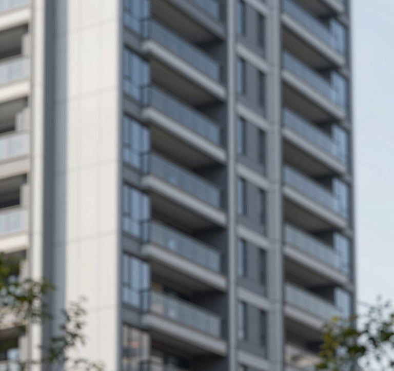 Architectural detail of a modern residential or corporate development. Focus on premium materials, clean vertical lines, and a sophisticated atmosphere. Brand palette tones are subtly visible in the shadows and glass reflections.