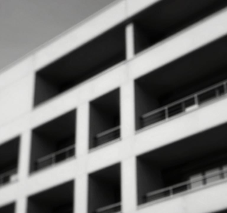 Dramatic black and white photography of a modern architectural structure with sharp lines and strong shadows, representing solidity and masculine strength.