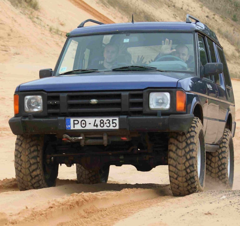 Jeep driving over sandy dunes during a 4x4 adventure near Riga