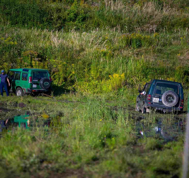 Muddy off-road track with a 4x4 vehicle outside the city of Riga