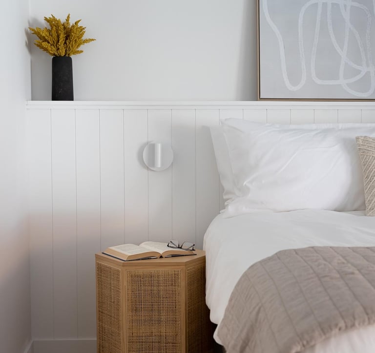 a bedroom with a bed and a lamp