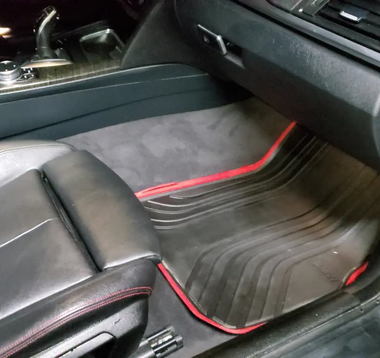 a car with a black leather seat and red trim