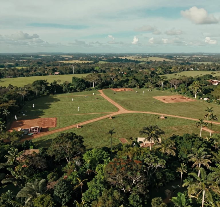 A wide, cinematic drone shot of a pristine, large plot of land ready for development in a South American / Brazilian landscape, lush greenery contrasting with early construction markers, professional photography, muted teal and light grayish blue sky.