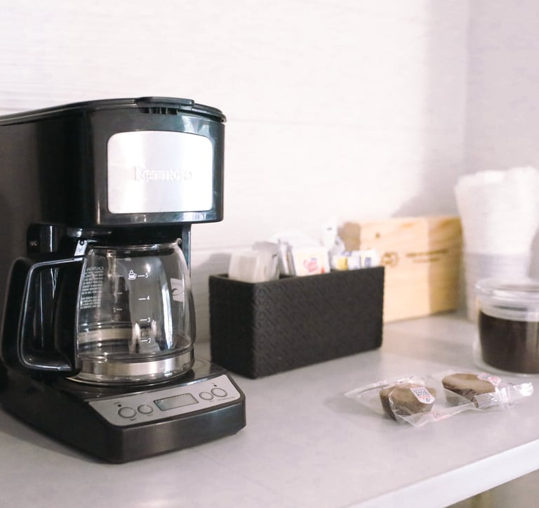 a coffee maker on a counter top with a coffee maker