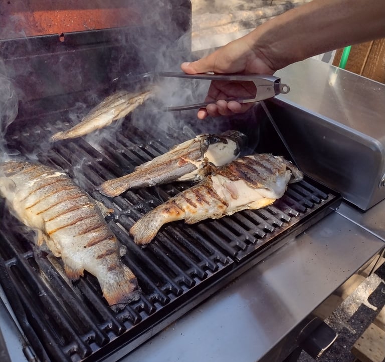 a person is cooking on a grill 