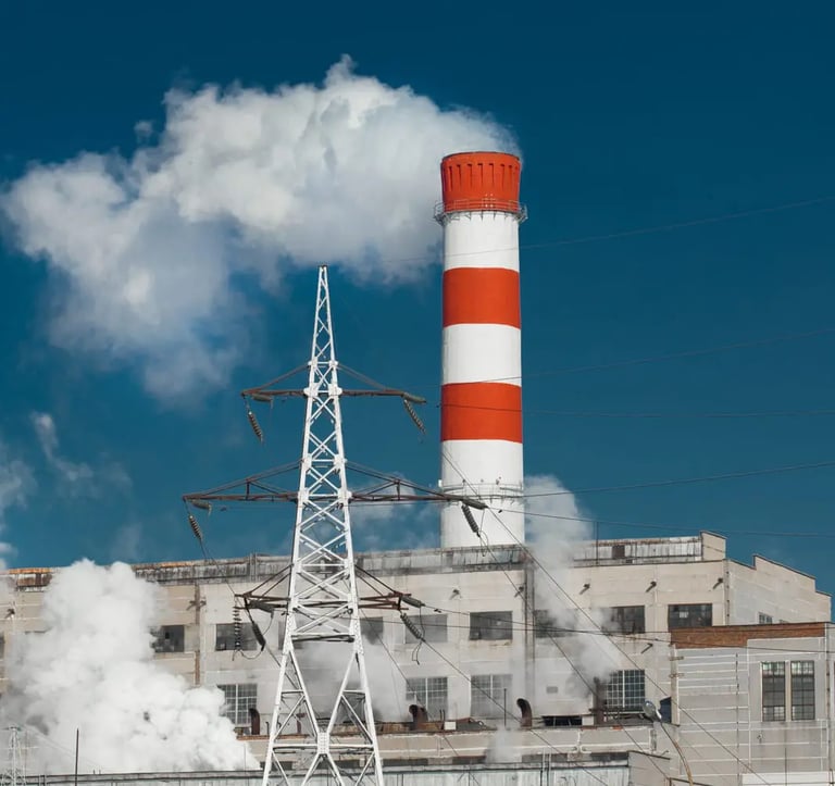 Smoke comming out of a red and white striped factory chimney