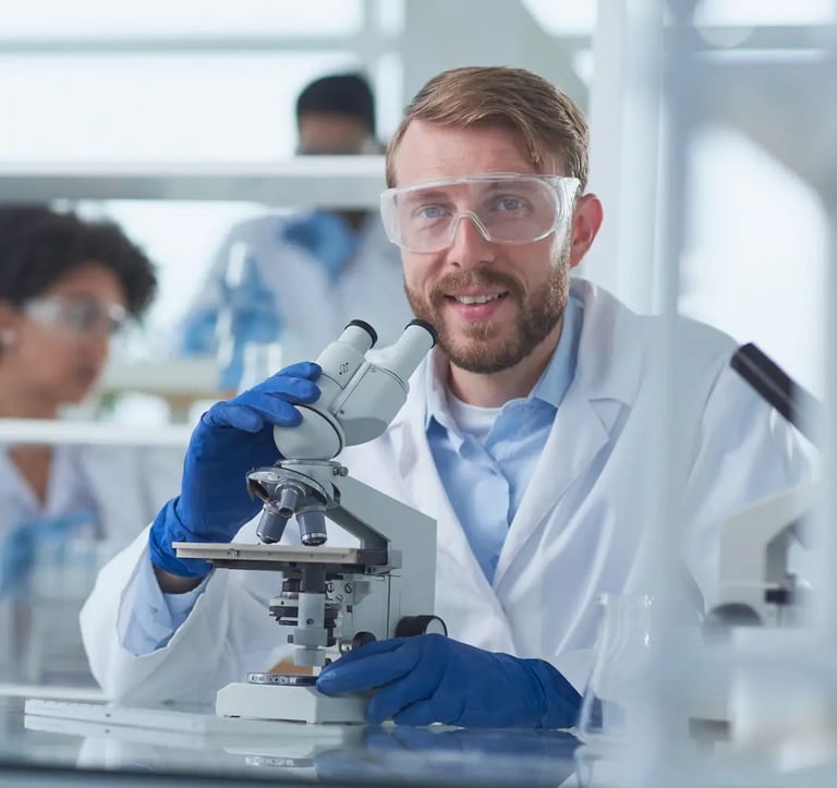 A scientist looking into a microscope