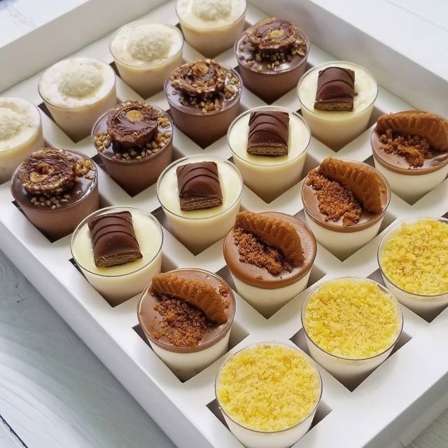 a box of desserts with chocolates and desserts
