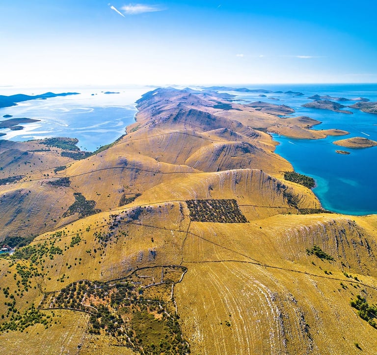 Aerial view of Kornati National Park archipelago with rocky islands and clear blue sea.