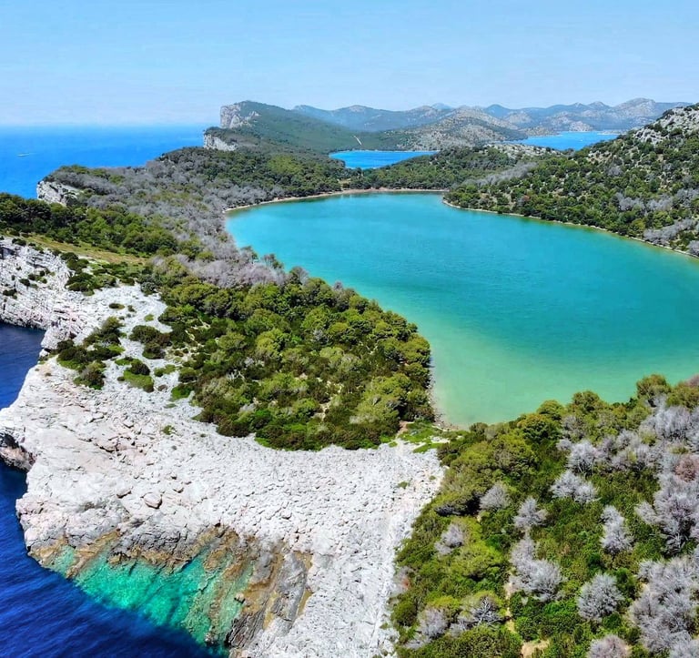 Cliffs of Telašćica Bay plunging into turquoise waters of Adriatic Sea.