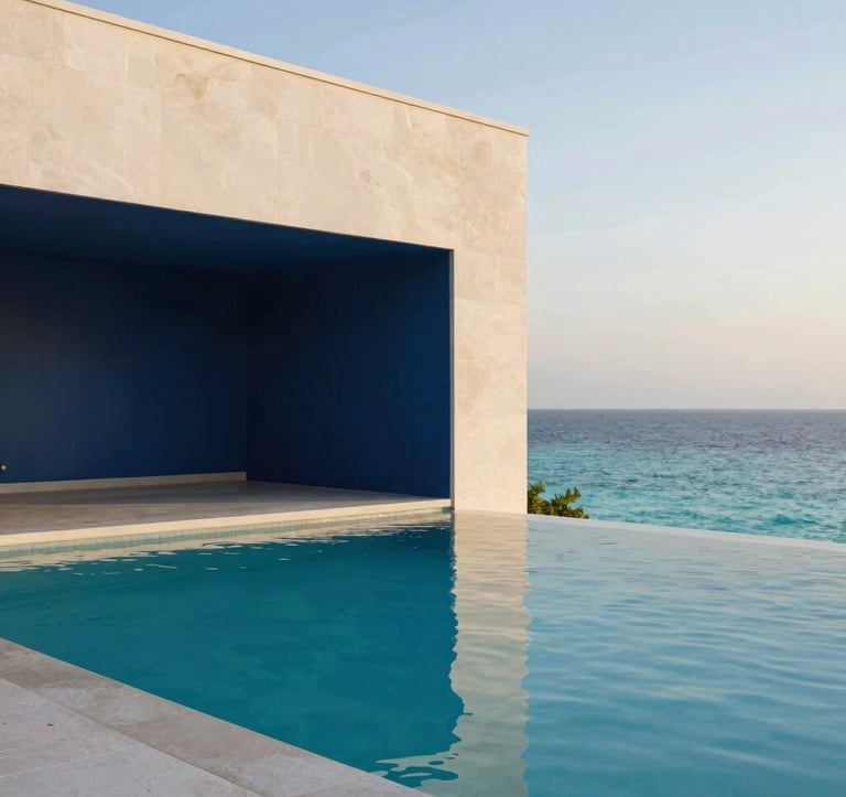 A close-up photograph of a luxury resort infinity pool that merges with a turquoise ocean at dawn. The architecture is modern and minimalist with clean lines. Soft off-white stone and deep navy blue shadows create a peaceful, premium aesthetic. Global / Sophisticated Traveler setting.