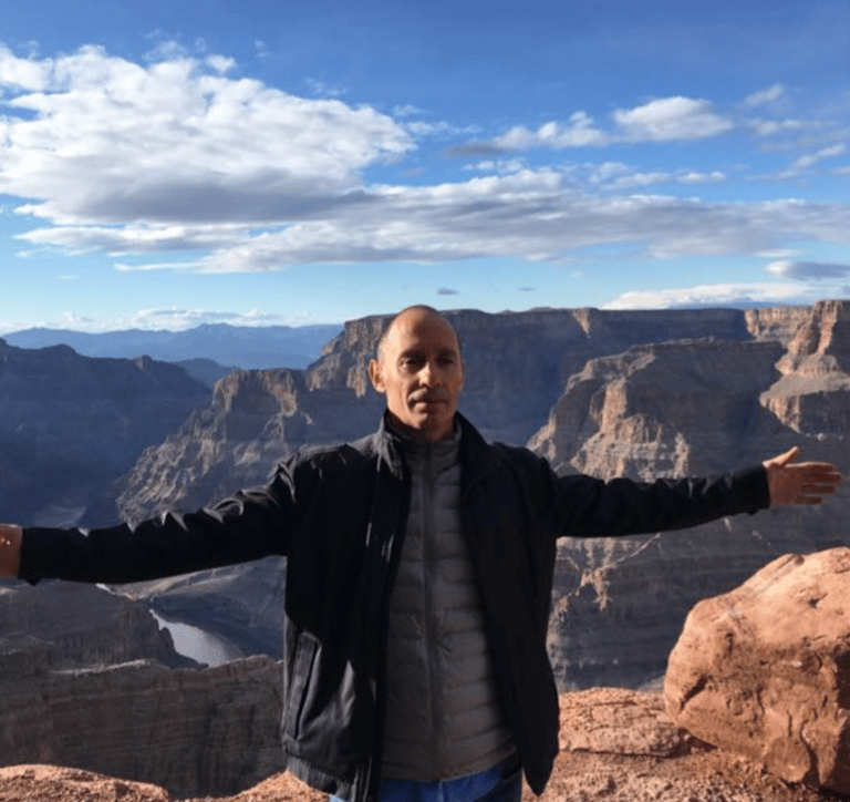 a man standing on a cliff overlooking a canyon