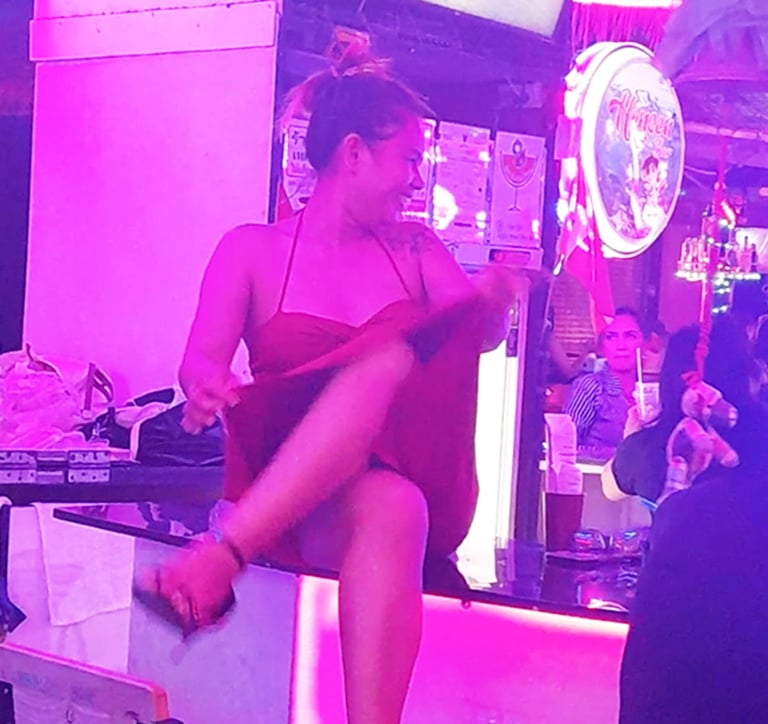 Thai woman sat on bar at Wonderland bar complex, Hua Hin