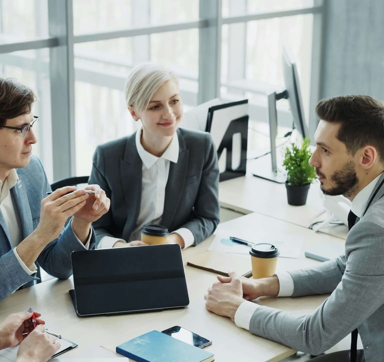 Meeting of four people discussing strategy and results