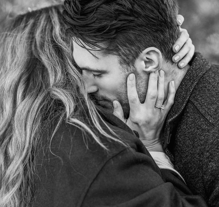 a man and woman kissing in black and white