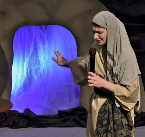 A woman dressed in a biblical costume performing.