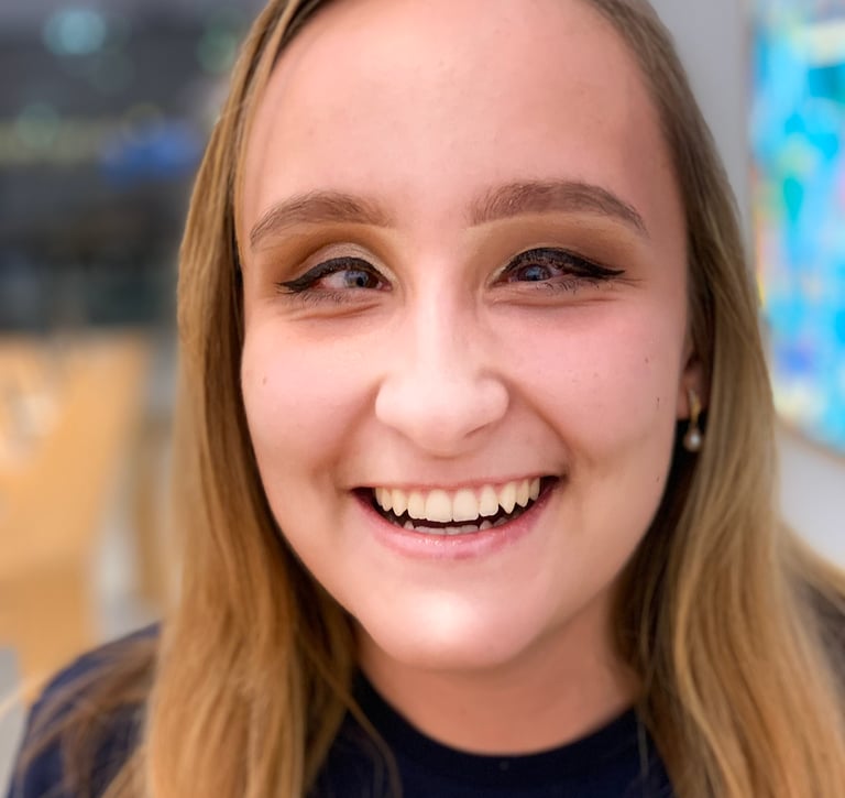 A blond-haired woman founder Zhenya Pankova, smiles at the camera.