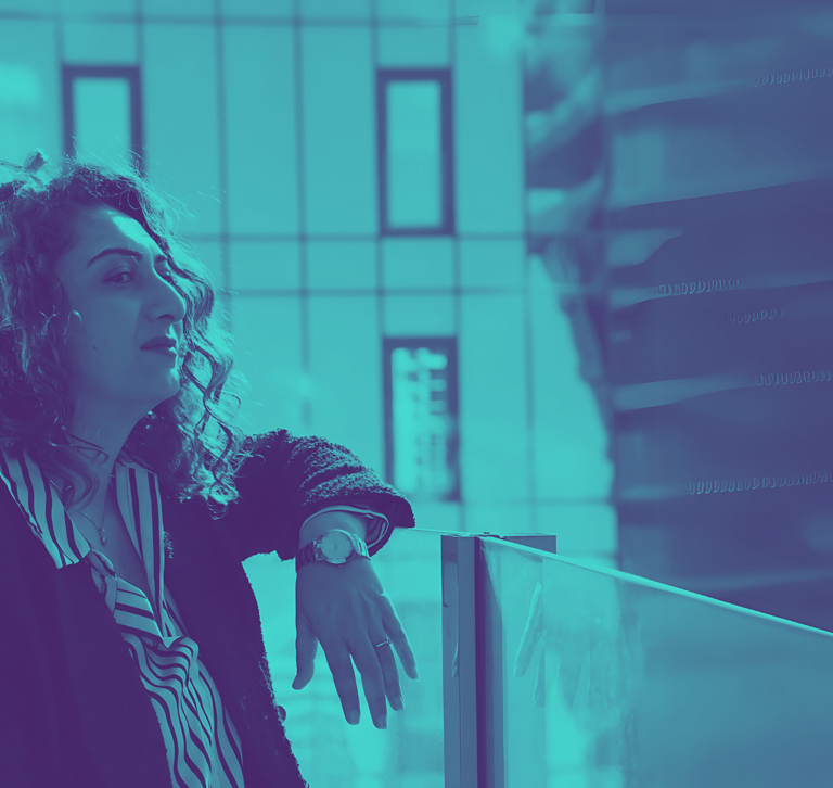 a woman Daya Jadhav in a black jacket and a blue sky