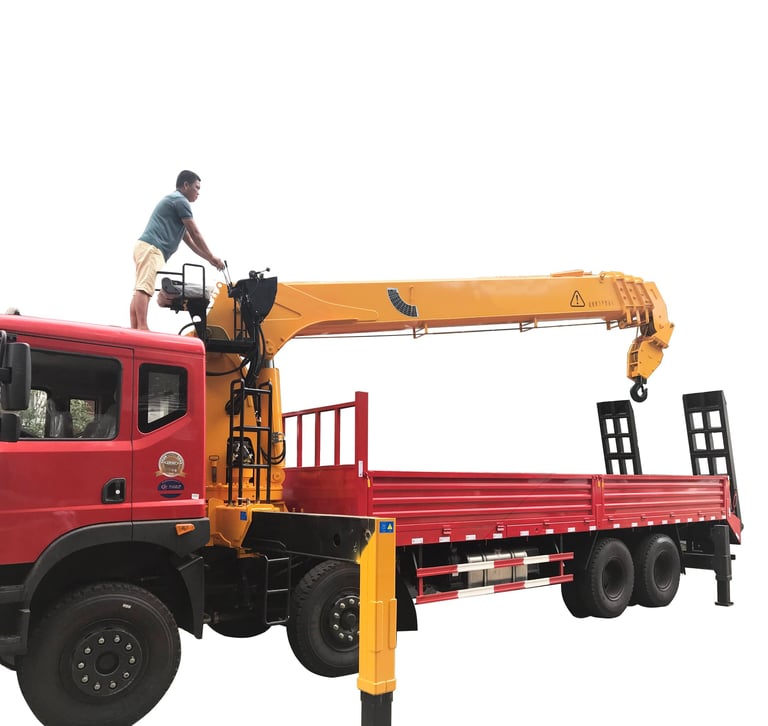 A man standing on top of a 14 ton Telescopic Boom Truck Mounted Crane with 4 section arms.