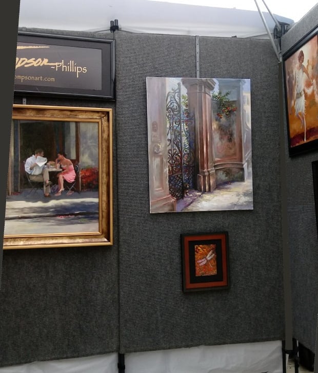Art show paintings inside tent