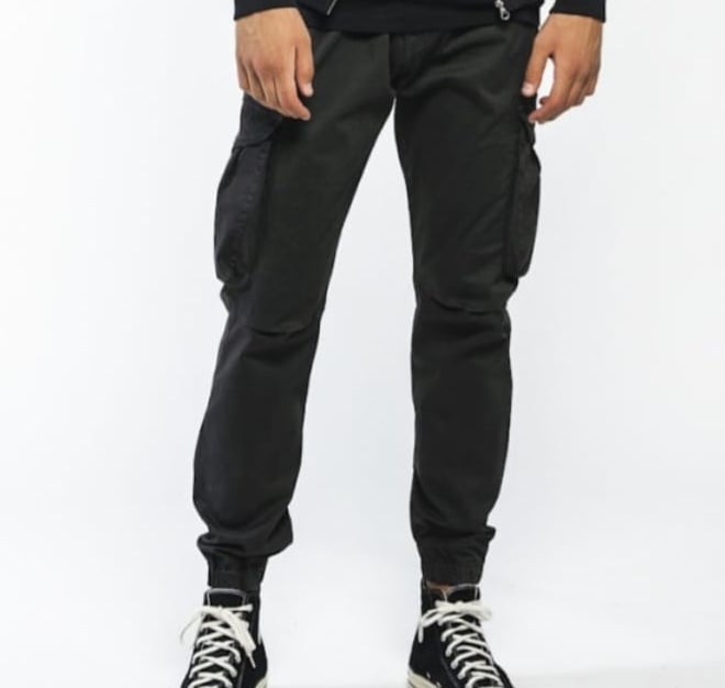 a man in a black hoodie and black pants