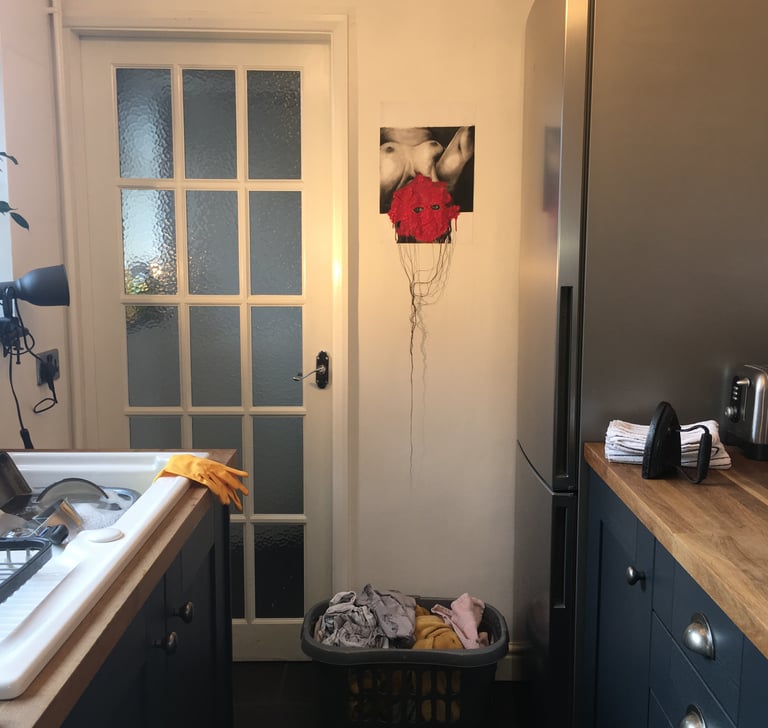 image of nude woman with censored face curated in a domestic kitchen space