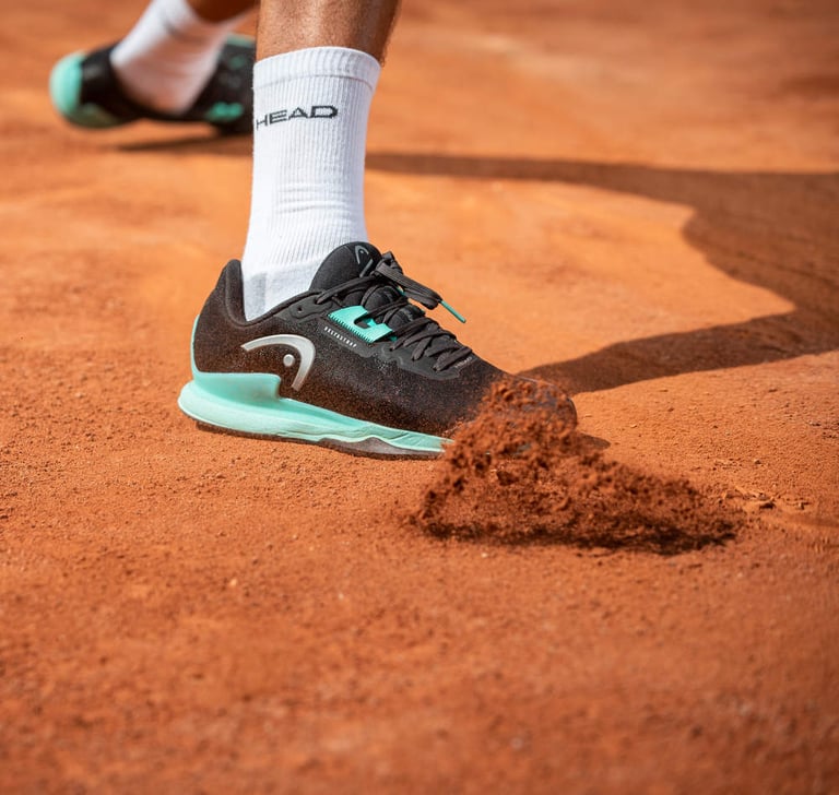 a tennis player's foot in the middle of a tennis court