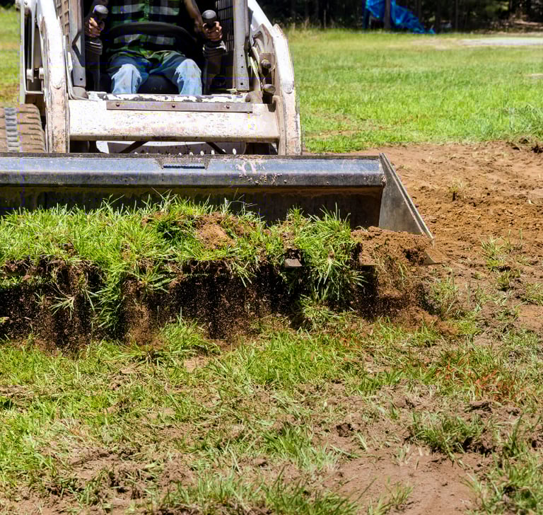 skid-steer-bucket-hauling-dirt.png