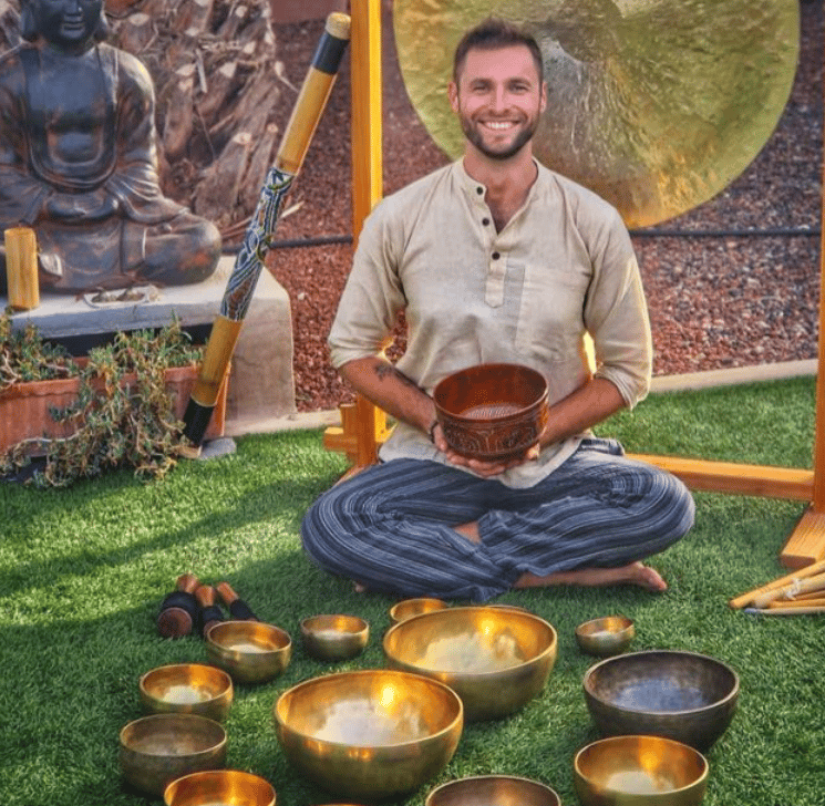 csaba seated in the middle of all sound therapy  instruments