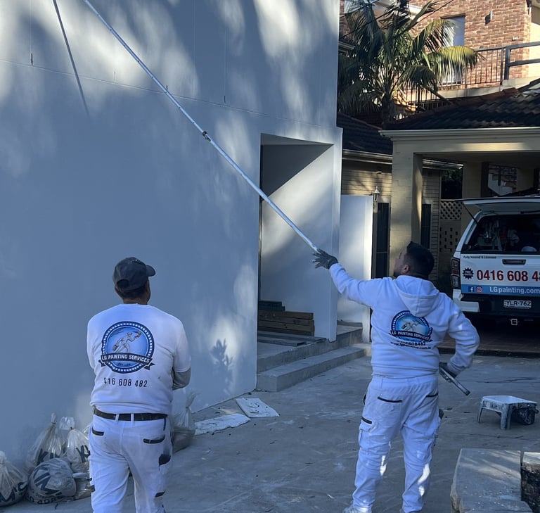 LG painting Servises in white suits and white shirts are painting a wall