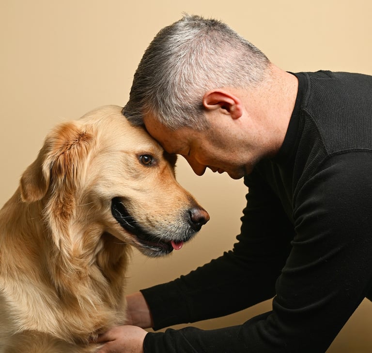 a man is petting a golden retriever