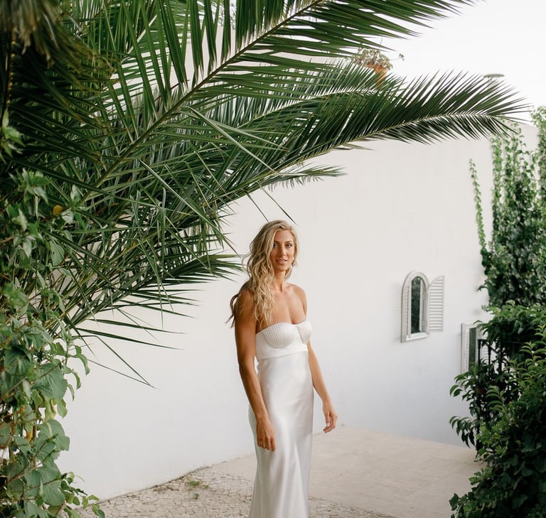 Bride in a white wedding dress with loose long hair and beach waves