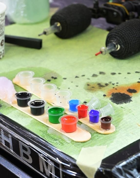 a table with paint and brushes and paint