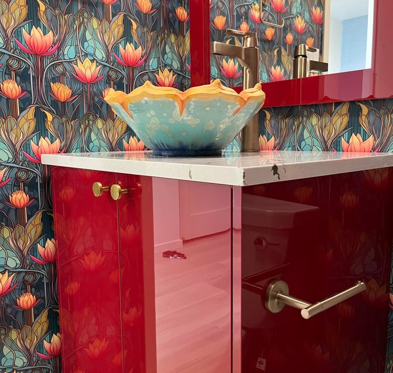 a designer sink bowl on a counter top, glossly red cabinet