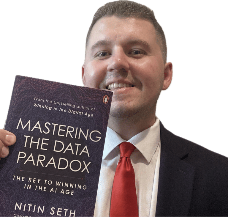 Jake Byford holding the book Mastering the Data Paradox