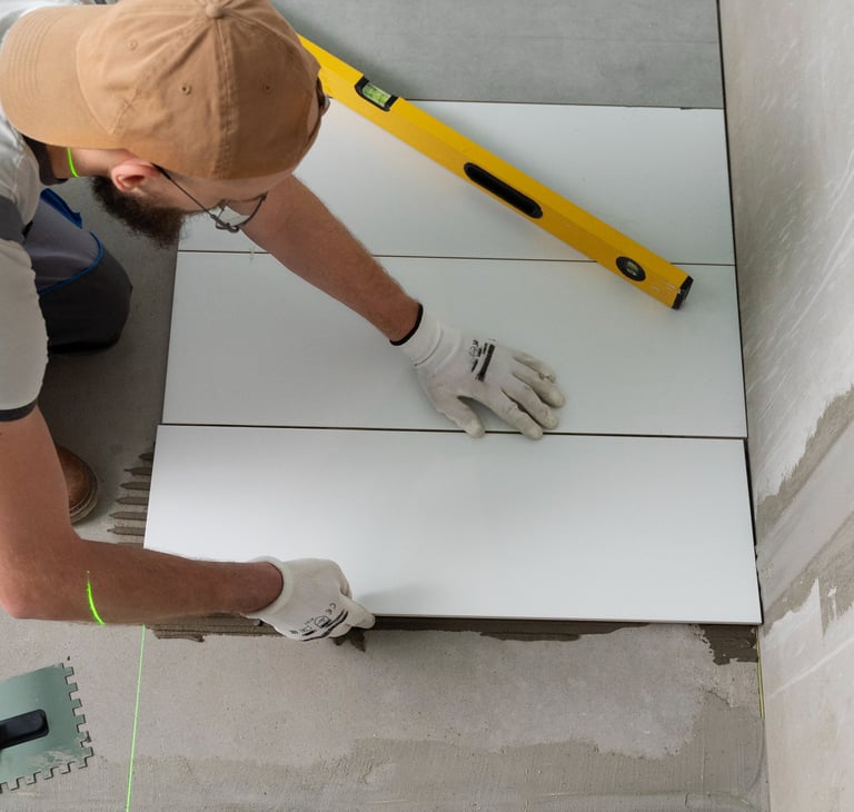 a man is working on a tile floor