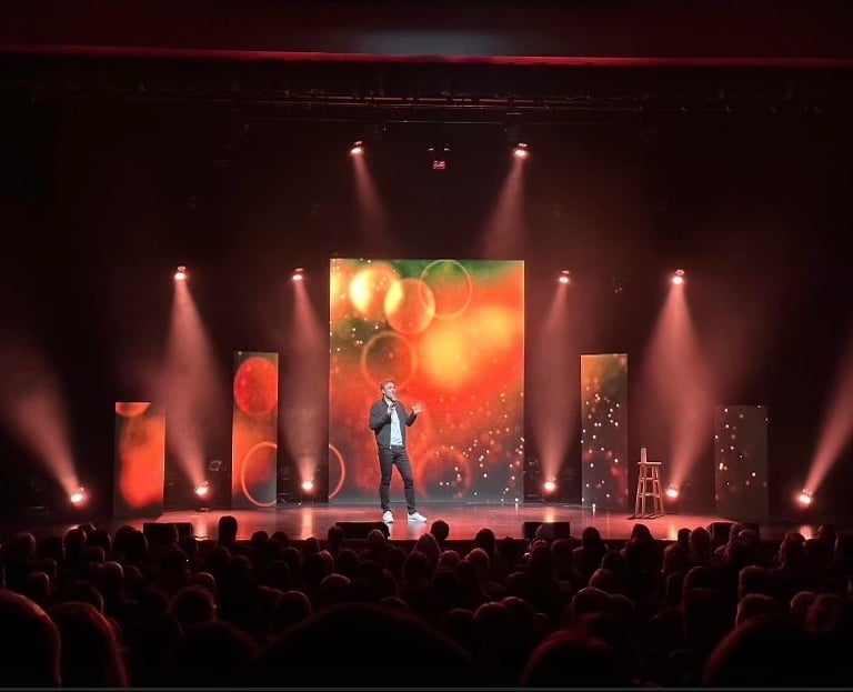 Stage with light and a person who talk to the crowd