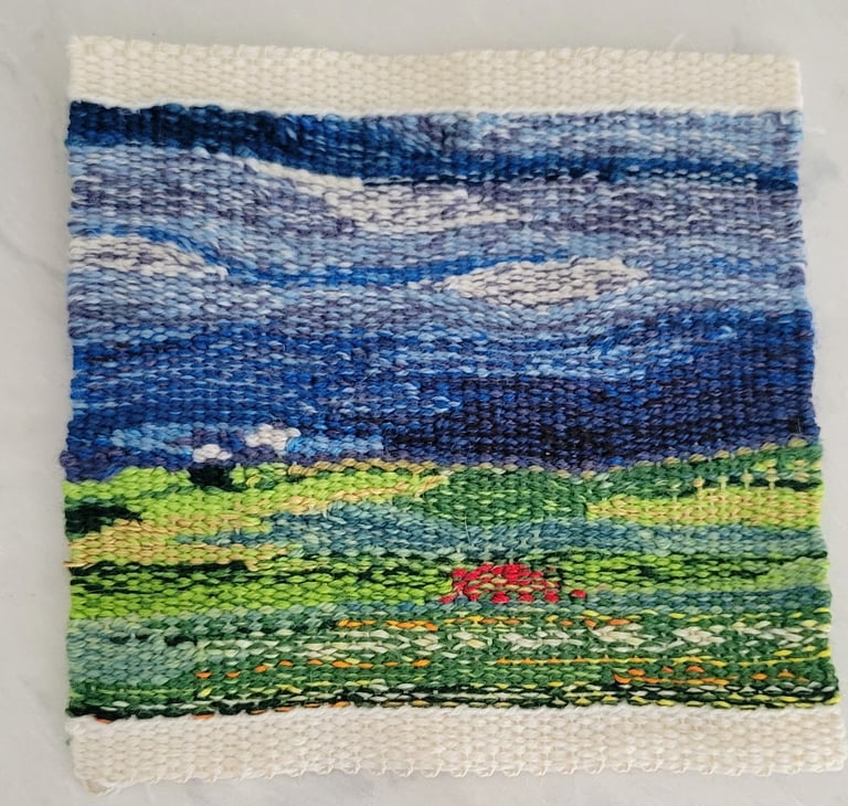 Hand-woven abstract tapestry of field and sky.