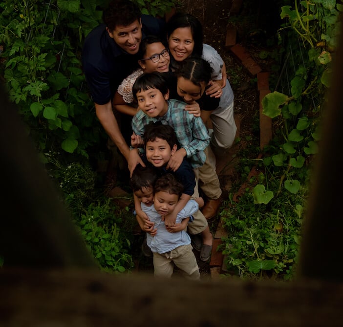 All eight members of the Schauder family posing in their garden. 