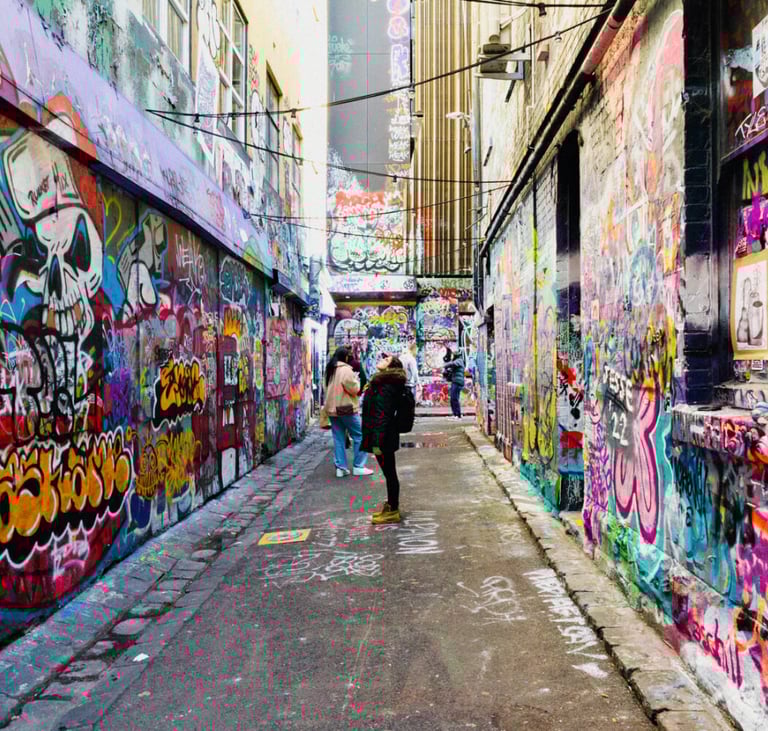 a person walking down a narrow alley with graffiti on the walls
