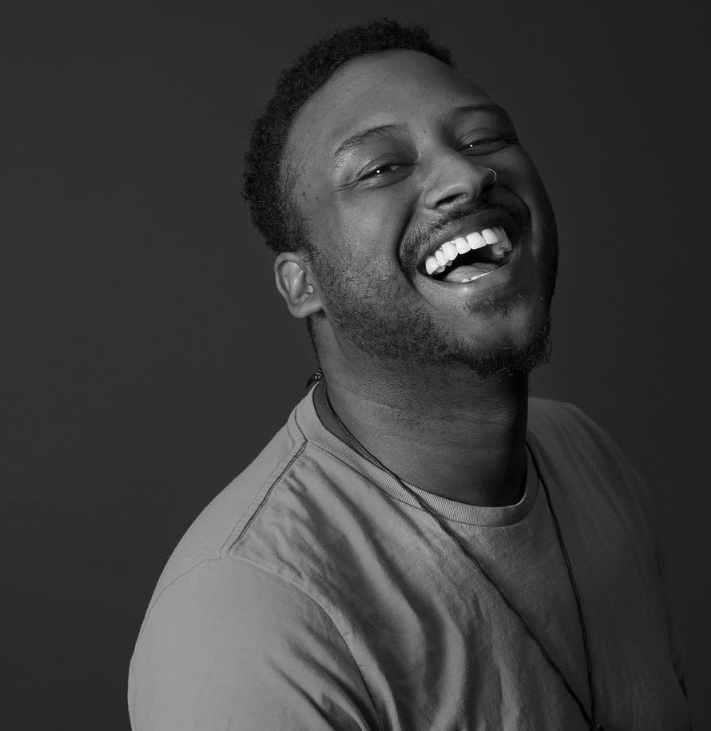 edwin bodney LA based spoken word poet laughs in black and white photo