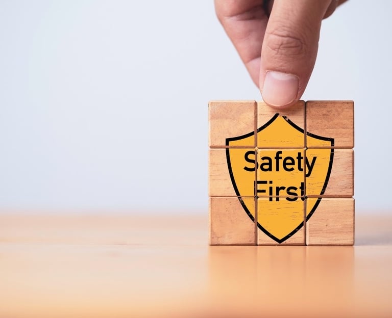Building blocks with the graphic of a yellow shield saying "Safety First" on the front