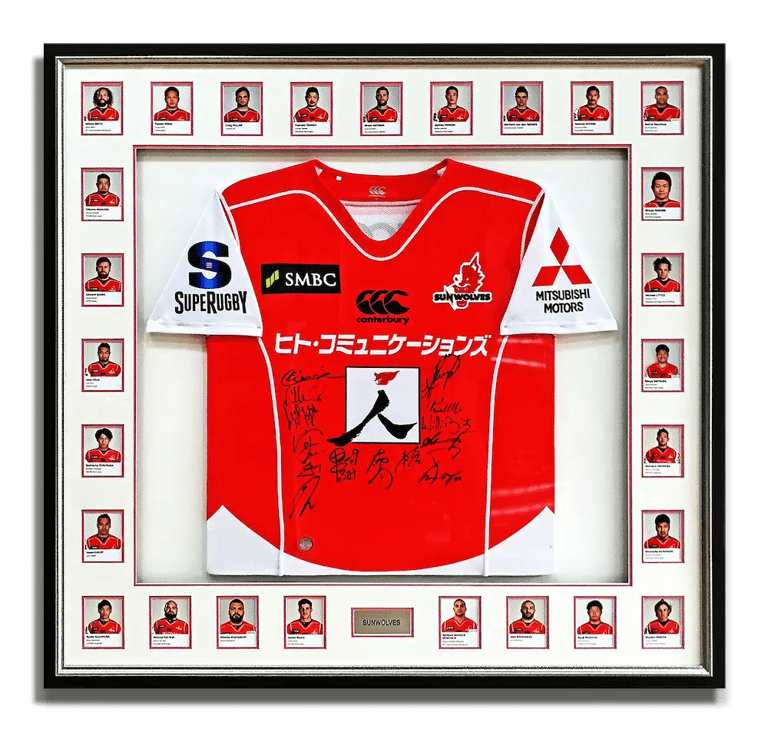 A frame showcasing a team signed Sun Wolves rugby jersey along with all team members' photos.